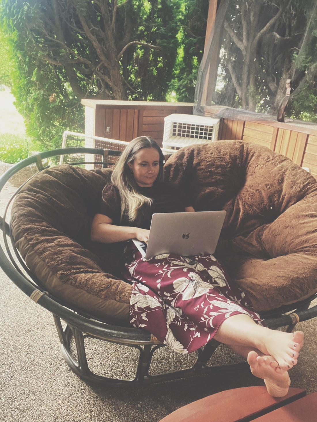 Erin Cronie relaxing and coding in a papadam chair